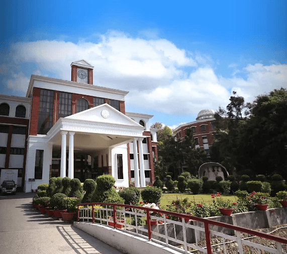 Graphic Era Deemed to be University (GEU) Dehradun modern campus building with lush green surroundings